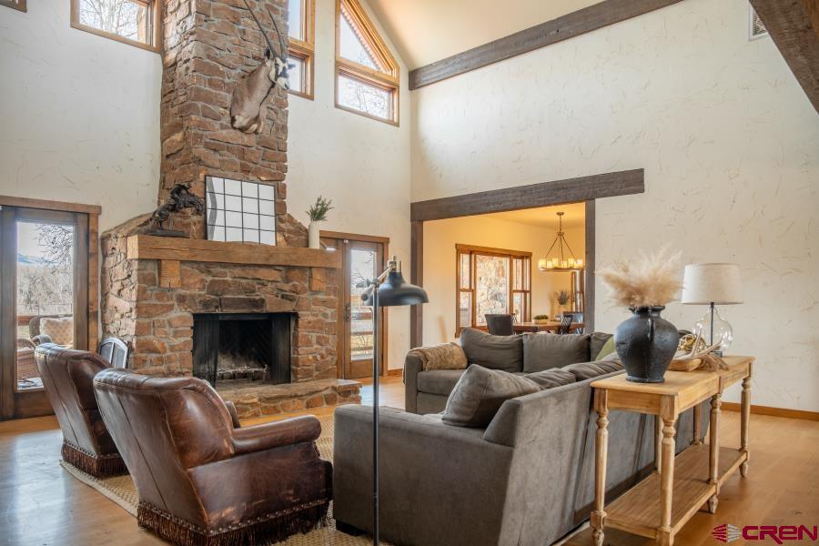 66961 Solar Road Montrose, CO 81403 - Photo 11 of 44 a living room with furniture fireplace and a large window