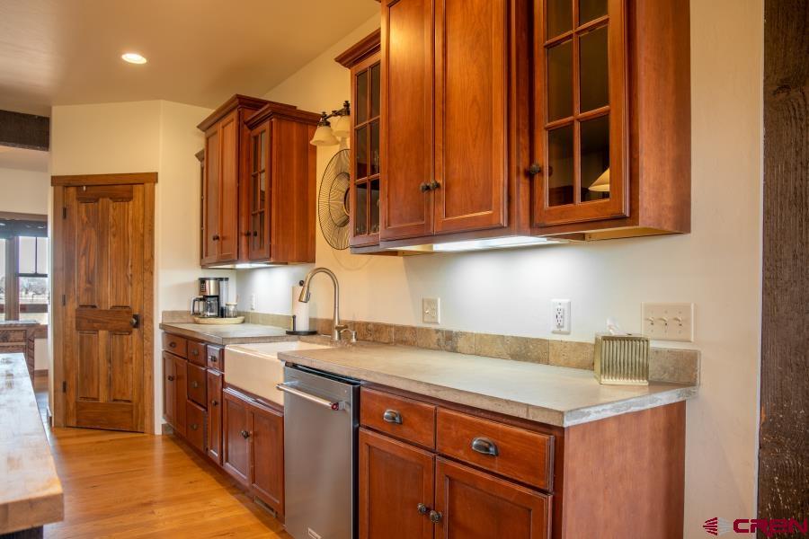 66961 Solar Road Montrose, CO 81403 - Photo 17 of 44 a kitchen with a sink cabinets and a wooden floor