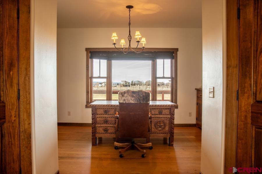 66961 Solar Road Montrose, CO 81403 - Photo 19 of 44 a view of a workspace with furniture and a window