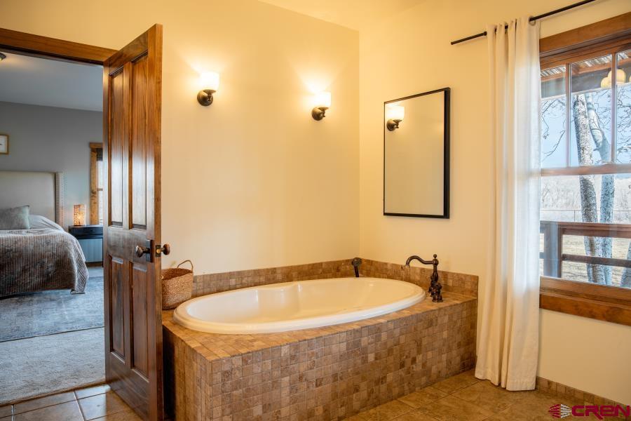 66961 Solar Road Montrose, CO 81403 - Photo 26 of 44 a bathroom with a tub and shower