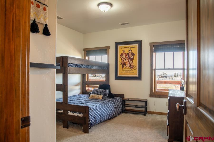 66961 Solar Road Montrose, CO 81403 - Photo 27 of 44 a bedroom with furniture and windows