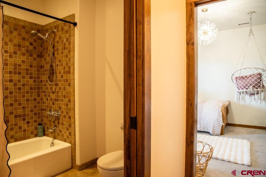 66961 Solar Road Montrose, CO 81403 - Photo 28 of 44 a bathroom with a toilet and shower