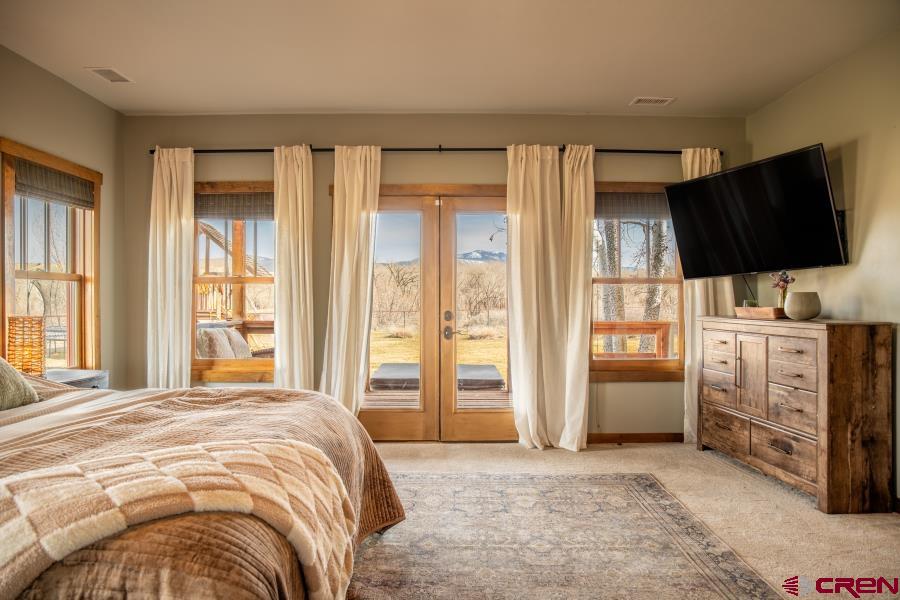 66961 Solar Road Montrose, CO 81403 - Photo 36 of 44 a bedroom with a bed a flat screen tv and dresser