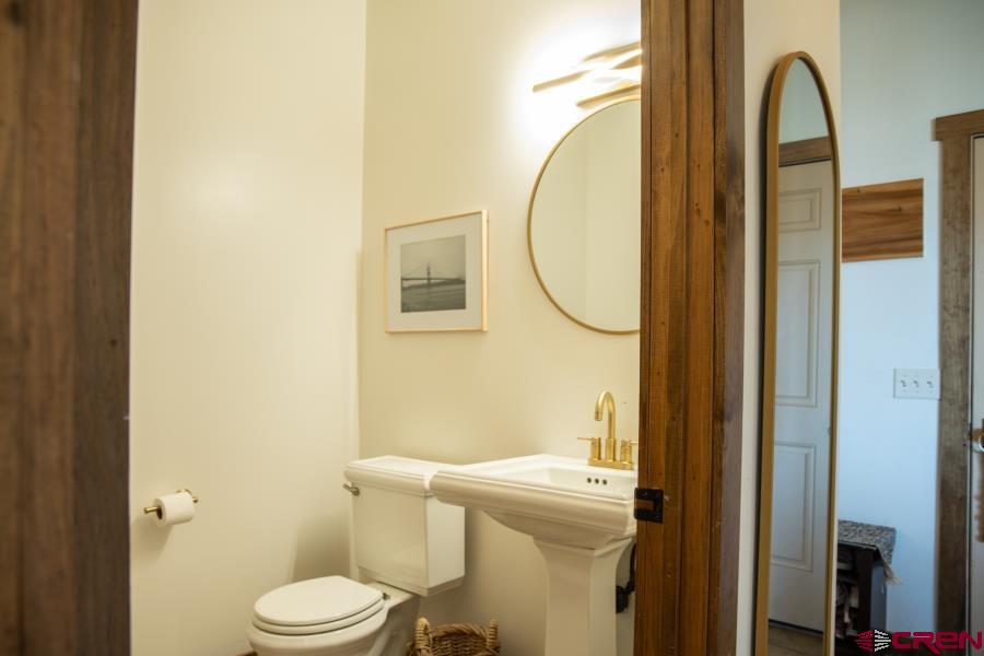 66961 Solar Road Montrose, CO 81403 - Photo 38 of 44 a bathroom with a granite countertop toilet and a sink
