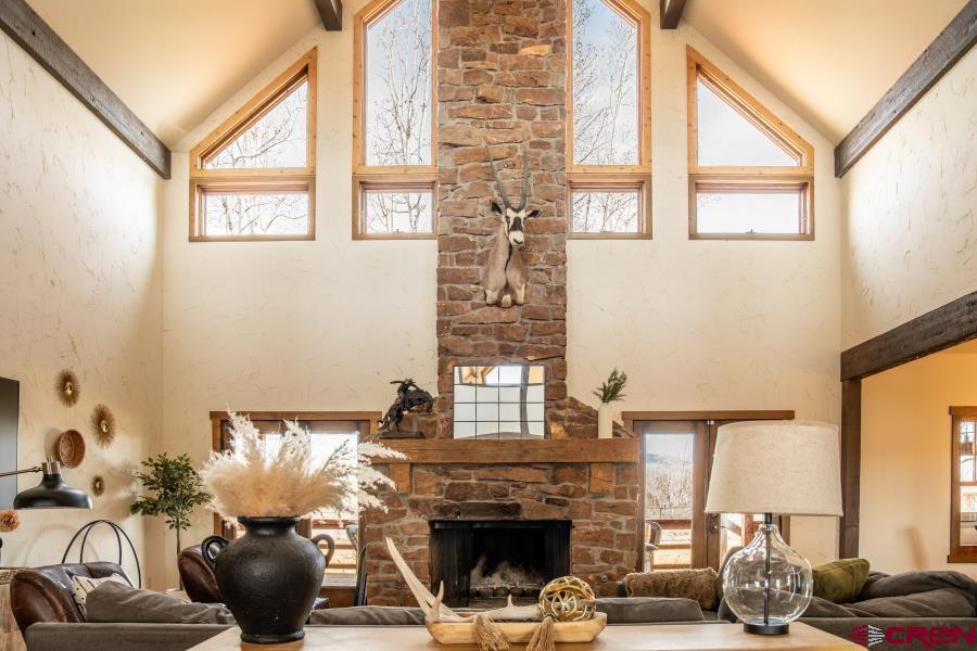 66961 Solar Road Montrose, CO 81403 - Photo 10 of 44 a living room with furniture a fireplace and a large window