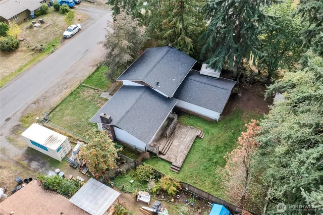 an aerial view of a house with a yard