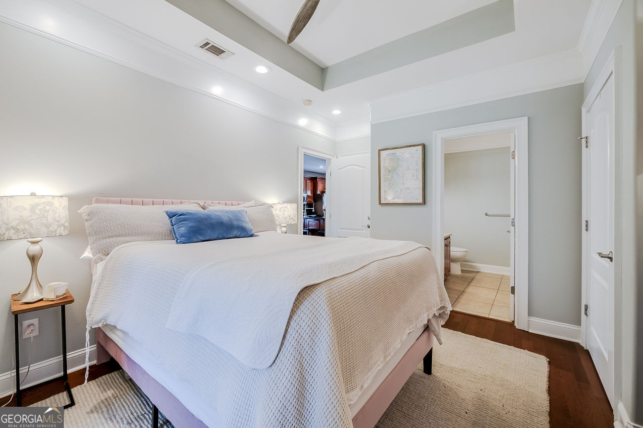 7272 Shellman Bluff Road Northeast, Unit 18 Townsend, GA 31331 - Photo 15 of 31 a bedroom with a large bed and a chandelier