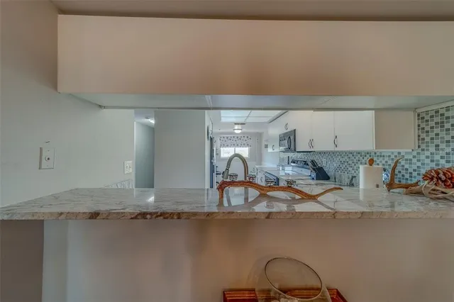 a kitchen with a sink and a stove top oven