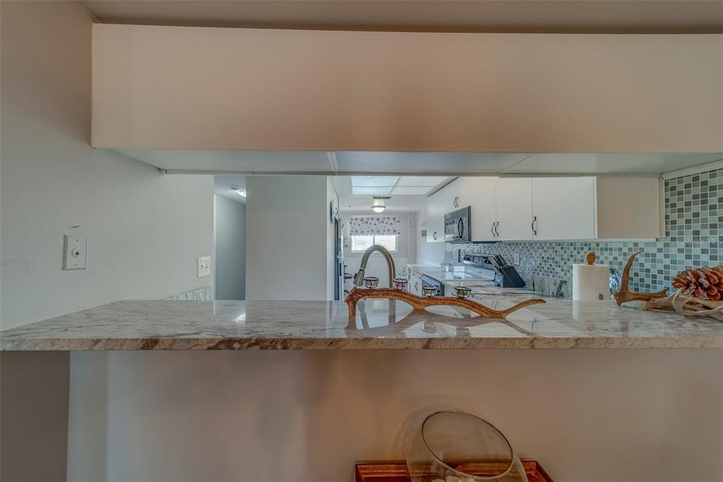 9510 Harbor Greens Way, Unit 407 Seminole, FL 33776 - Photo 12 of 41 a kitchen with a sink and a stove top oven