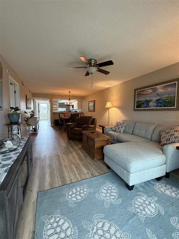 9510 Harbor Greens Way, Unit 407 Seminole, FL 33776 - Photo 14 of 41 a living room with furniture kitchen view and a large window