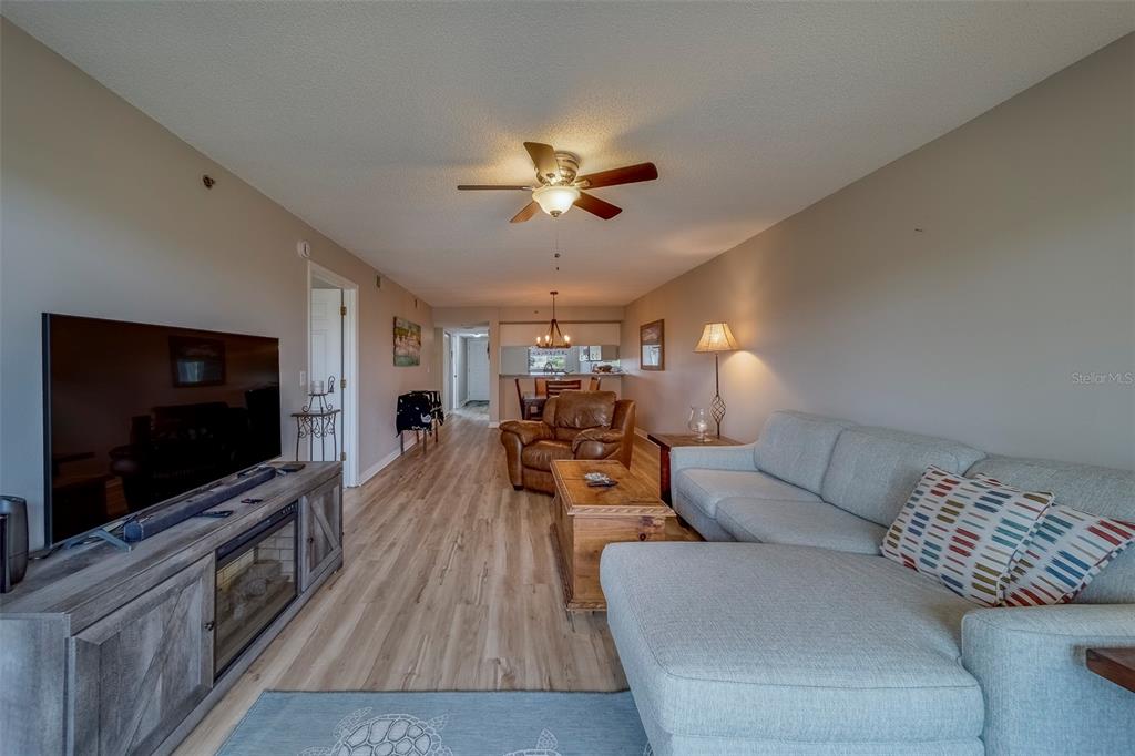 9510 Harbor Greens Way, Unit 407 Seminole, FL 33776 - Photo 15 of 41 a living room with furniture and a flat screen tv