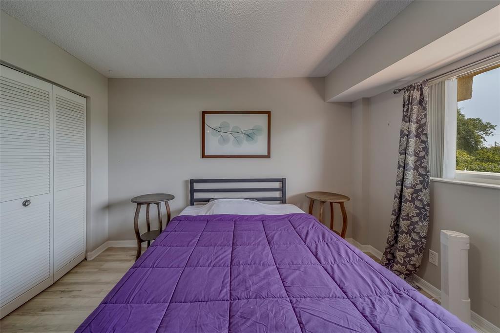 9510 Harbor Greens Way, Unit 407 Seminole, FL 33776 - Photo 20 of 41 a bedroom with a bed and a window