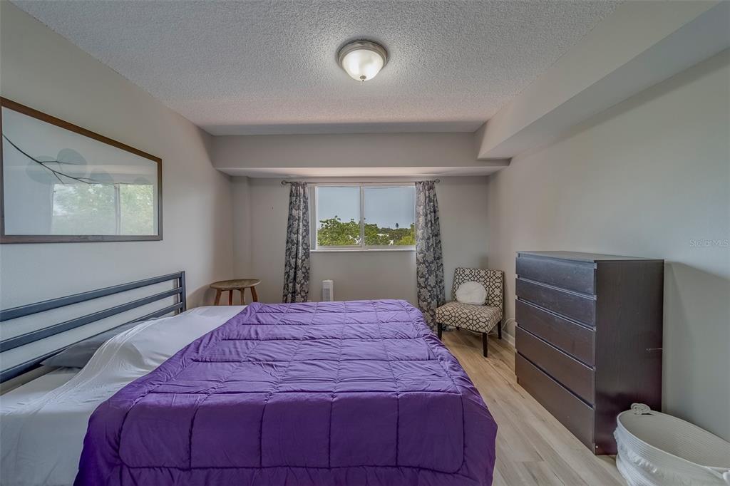 9510 Harbor Greens Way, Unit 407 Seminole, FL 33776 - Photo 21 of 41 a bedroom with a bed and a window