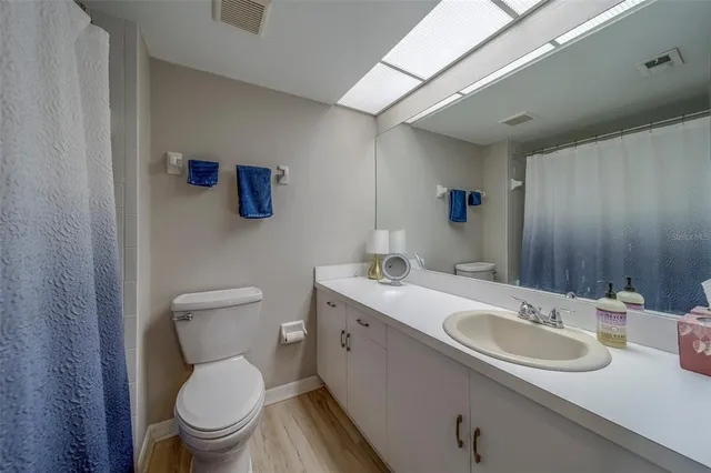 a bathroom with a sink toilet and mirror