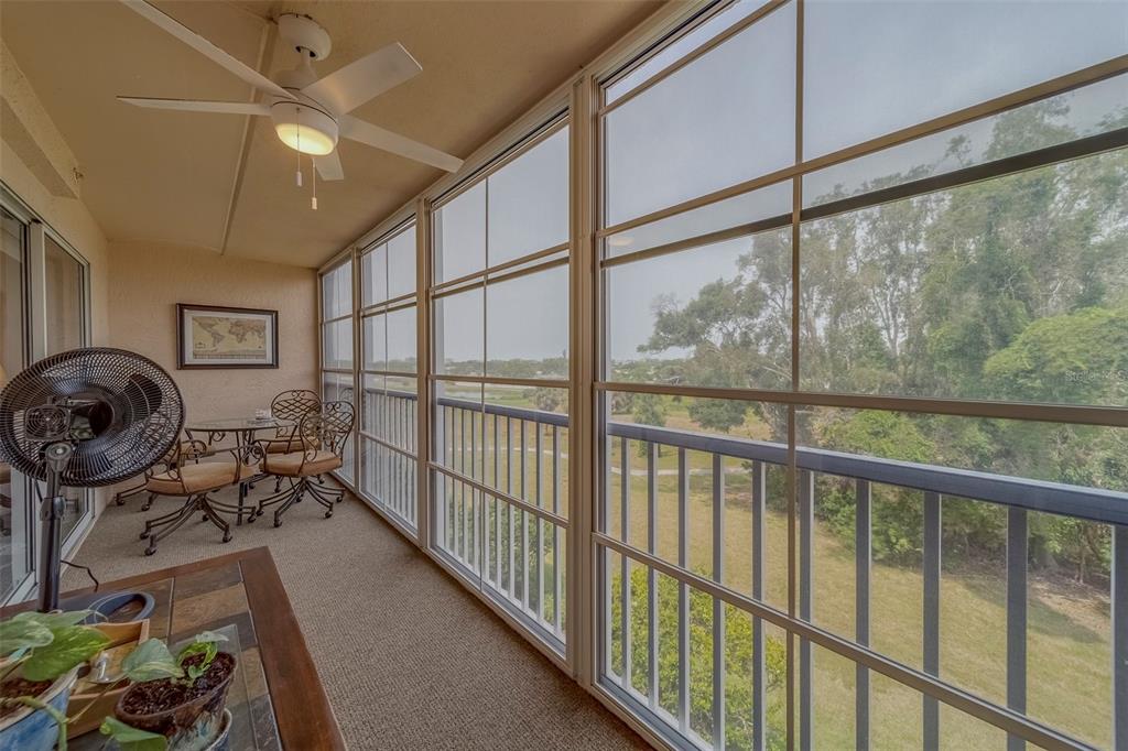 9510 Harbor Greens Way, Unit 407 Seminole, FL 33776 - Photo 27 of 41 a view of a chairs and table in a balcony