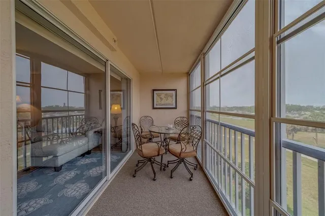 a balcony with furniture and view of city