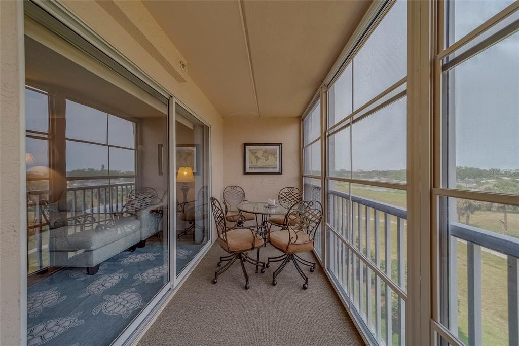 9510 Harbor Greens Way, Unit 407 Seminole, FL 33776 - Photo 28 of 41 a balcony with furniture and view of city