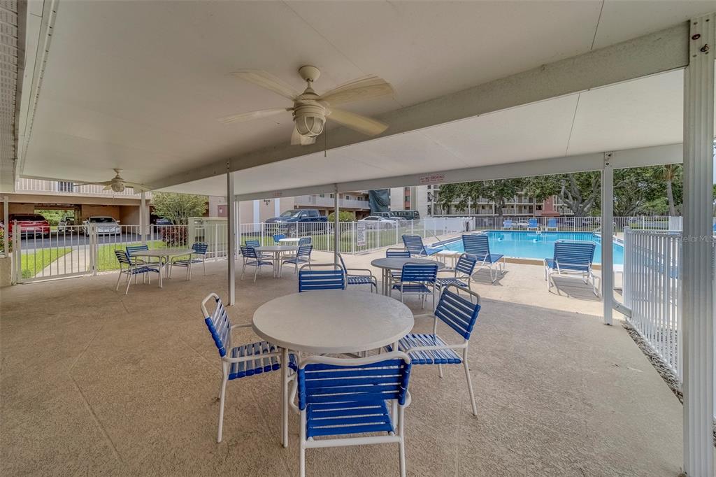 9510 Harbor Greens Way, Unit 407 Seminole, FL 33776 - Photo 30 of 41 a dining room with furniture and a floor to ceiling window