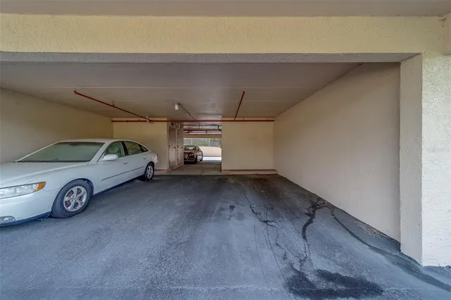 a view of garage with a car parked in it