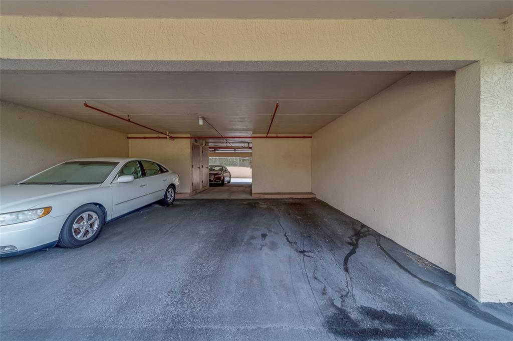 9510 Harbor Greens Way, Unit 407 Seminole, FL 33776 - Photo 3 of 41 a view of garage with a car parked in it