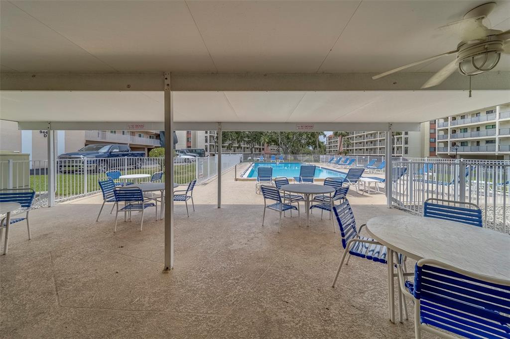 9510 Harbor Greens Way, Unit 407 Seminole, FL 33776 - Photo 31 of 41 a dining room with furniture and a floor to ceiling window