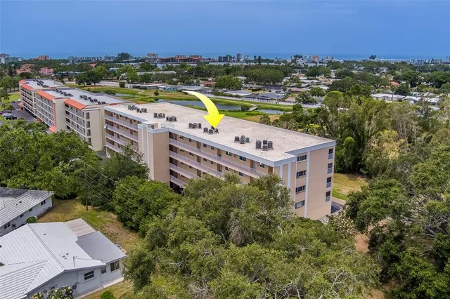 an aerial view of a house with a swimming pool outdoor seating and yard