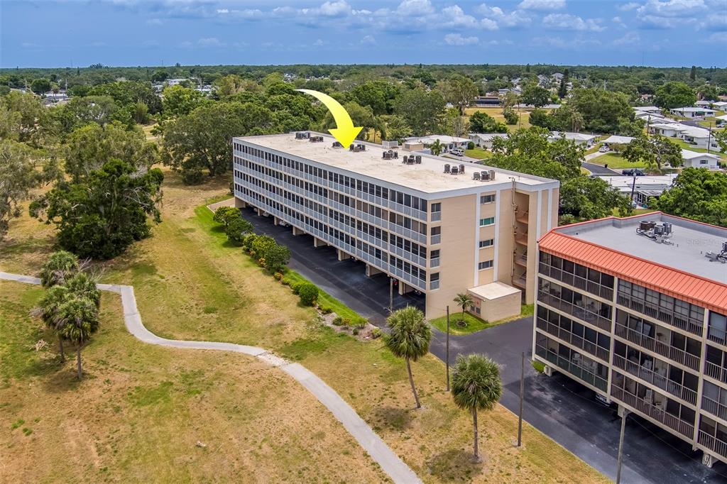 9510 Harbor Greens Way, Unit 407 Seminole, FL 33776 - Photo 38 of 41 a view of a chairs and table on the wooden floor