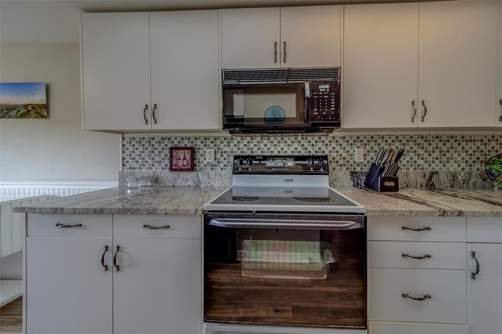 9510 Harbor Greens Way, Unit 407 Seminole, FL 33776 - Photo 8 of 41 a stove top oven sitting inside of a kitchen