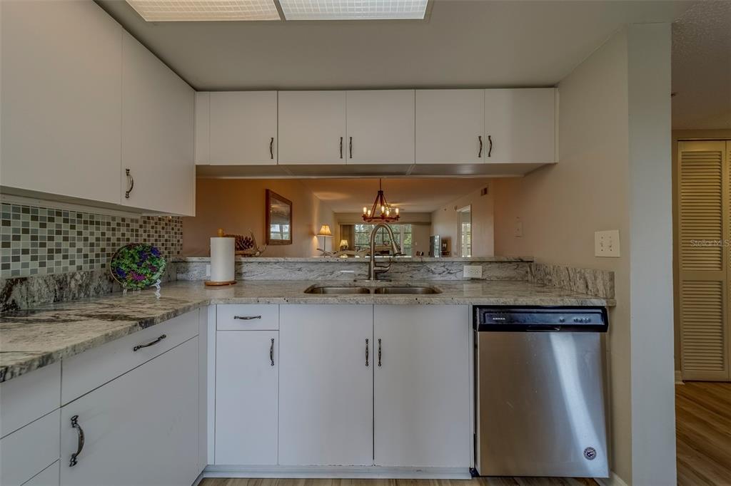 9510 Harbor Greens Way, Unit 407 Seminole, FL 33776 - Photo 10 of 41 a kitchen with stainless steel appliances granite countertop a sink and cabinets