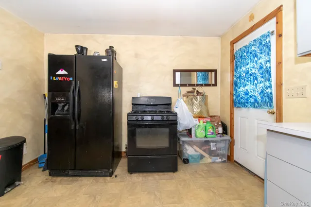 a kitchen with stainless steel appliances granite countertop a refrigerator and a stove