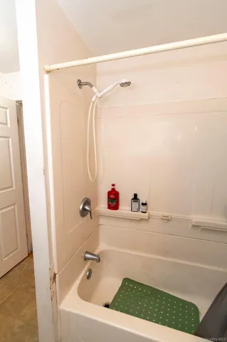 a bathroom with a tub and a shower