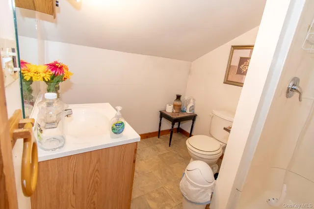 a bathroom with a sink toilet and a mirror