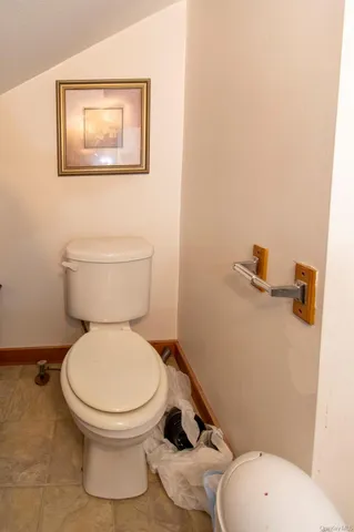 a white toilet sitting next to a bathroom sink