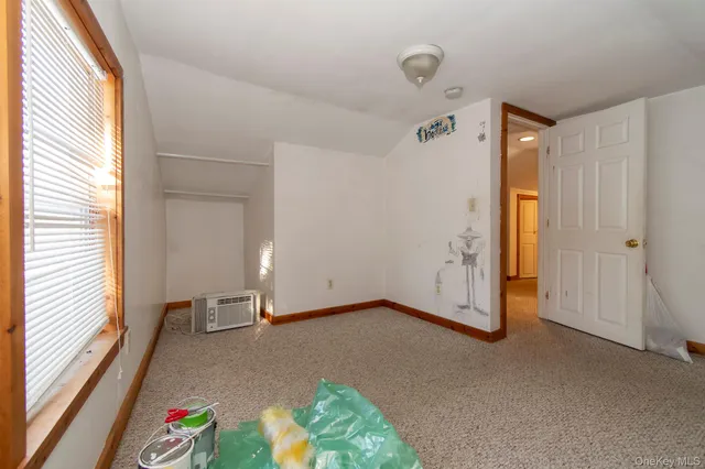 a view of an empty room and a window