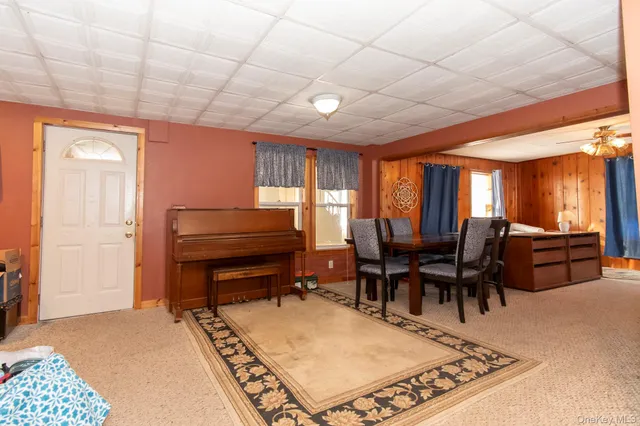 a living room with furniture a rug and a table
