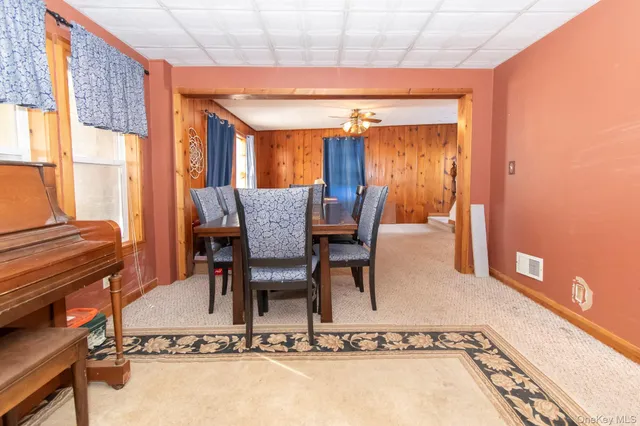 a dining room with furniture and a window