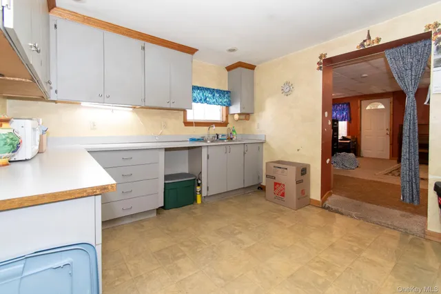 a kitchen with a sink stove and cabinets