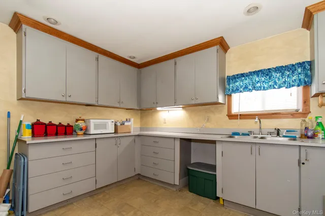 a kitchen with a sink cabinets and window