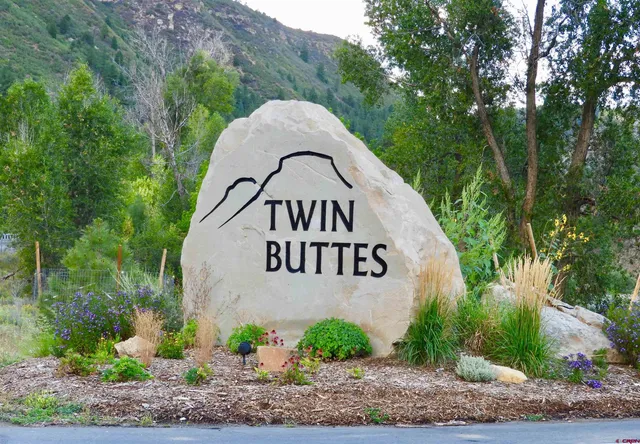 a view of a garden with a house