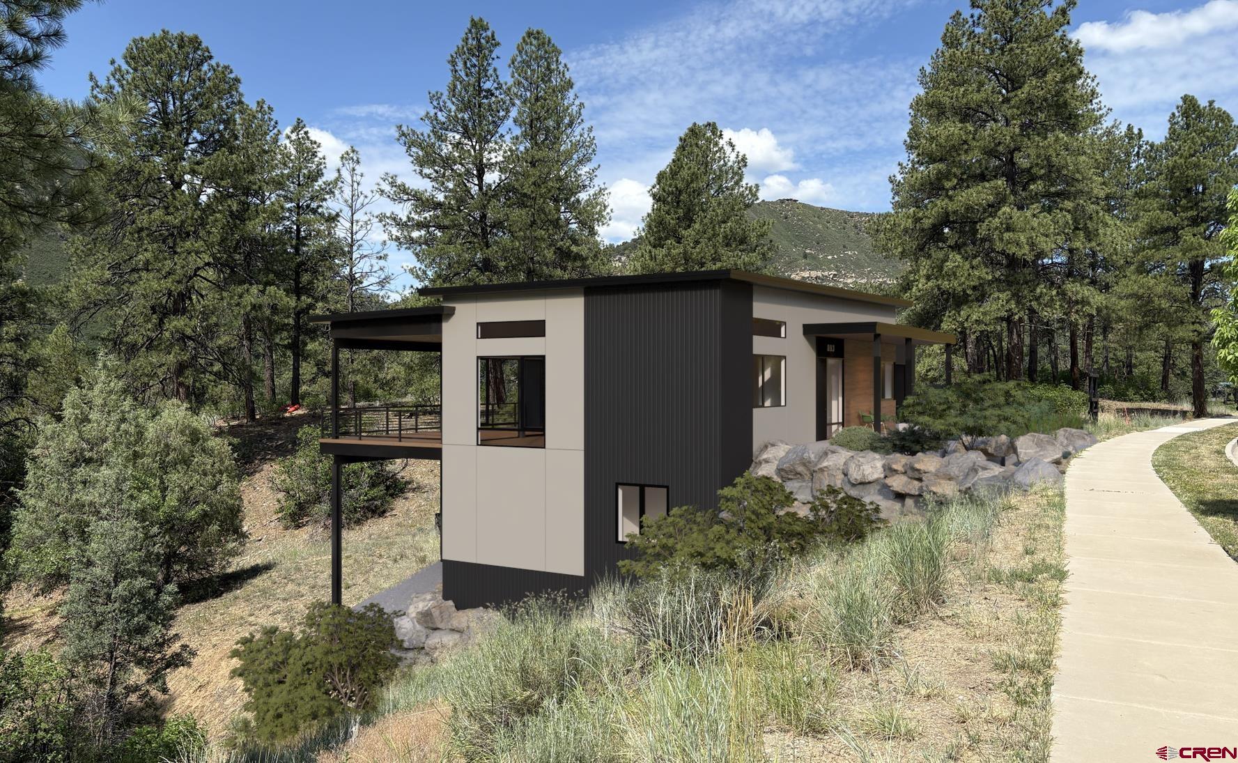893 Twin Buttes Avenue Durango, CO 81301 - Photo 3 of 20 a view of a white house in front of a yard with potted plants