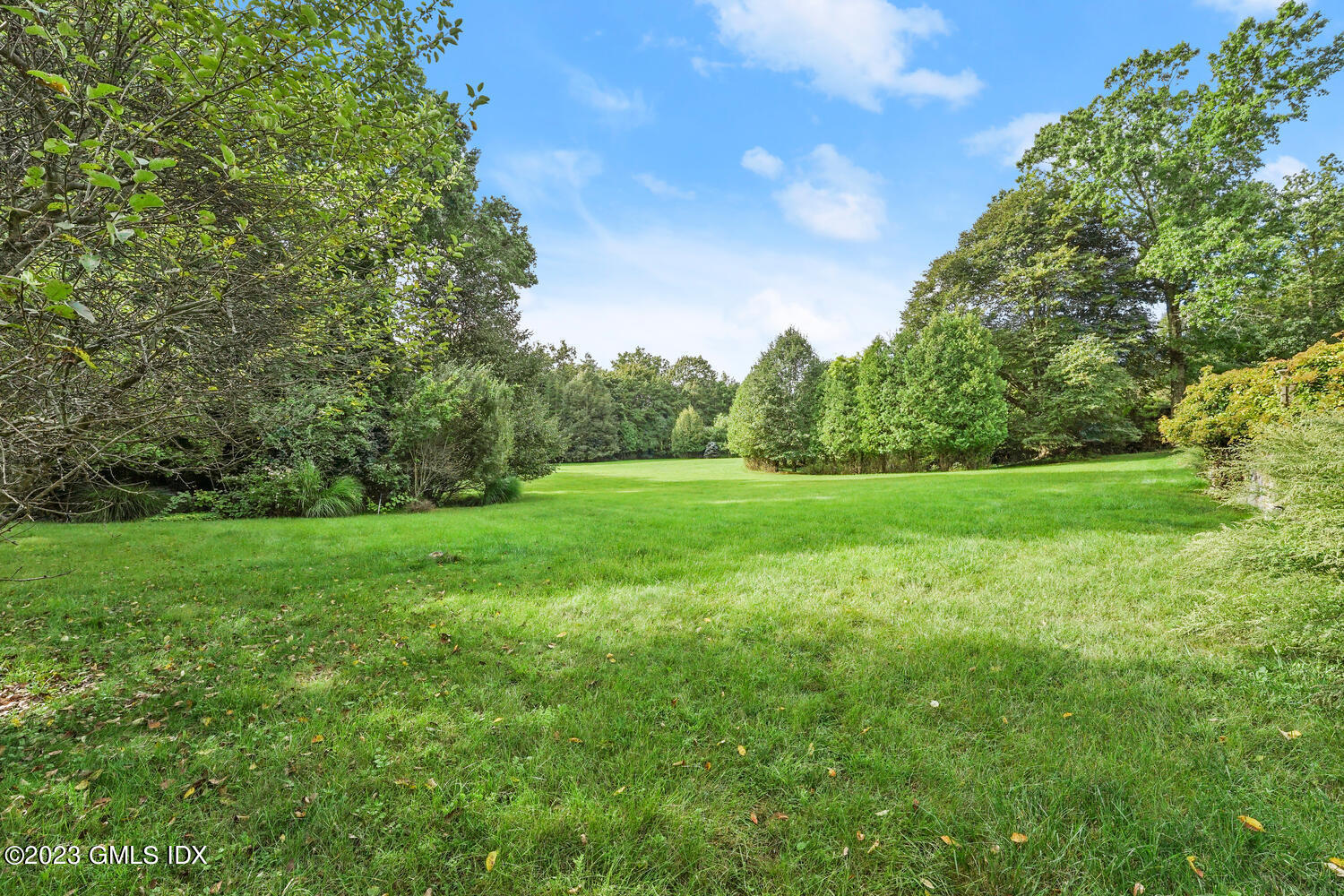 Undisclosed Address Greenwich, CT 06830 - Photo 5 of 5 a view of a grassy field with trees