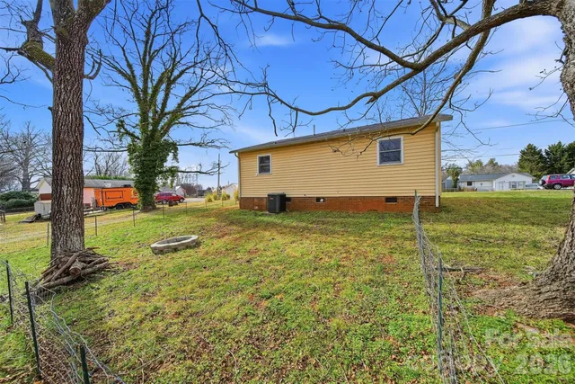 a view of a backyard with large trees