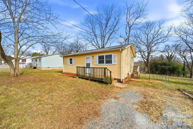a view of a house with a yard covered in snow