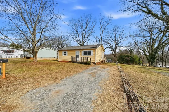 a front view of house with yard and trees
