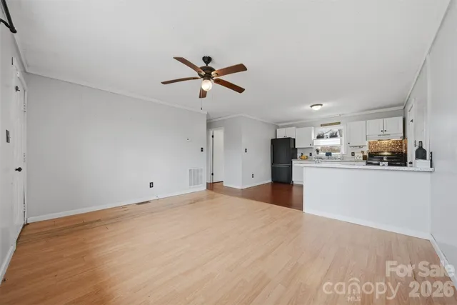 a view of a kitchen with a sink and refrigerator