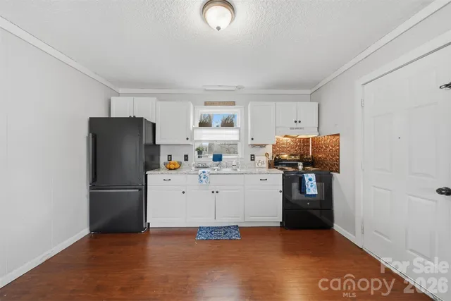 a kitchen with a refrigerator and a stove