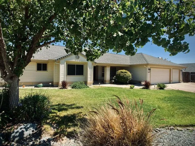 a front view of a house with a garden and porch