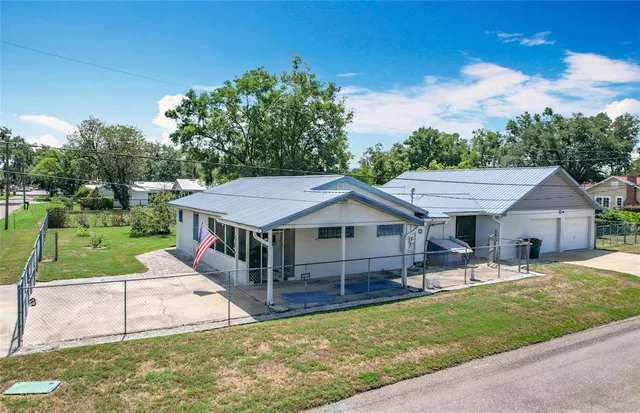 a house with green field in front of it