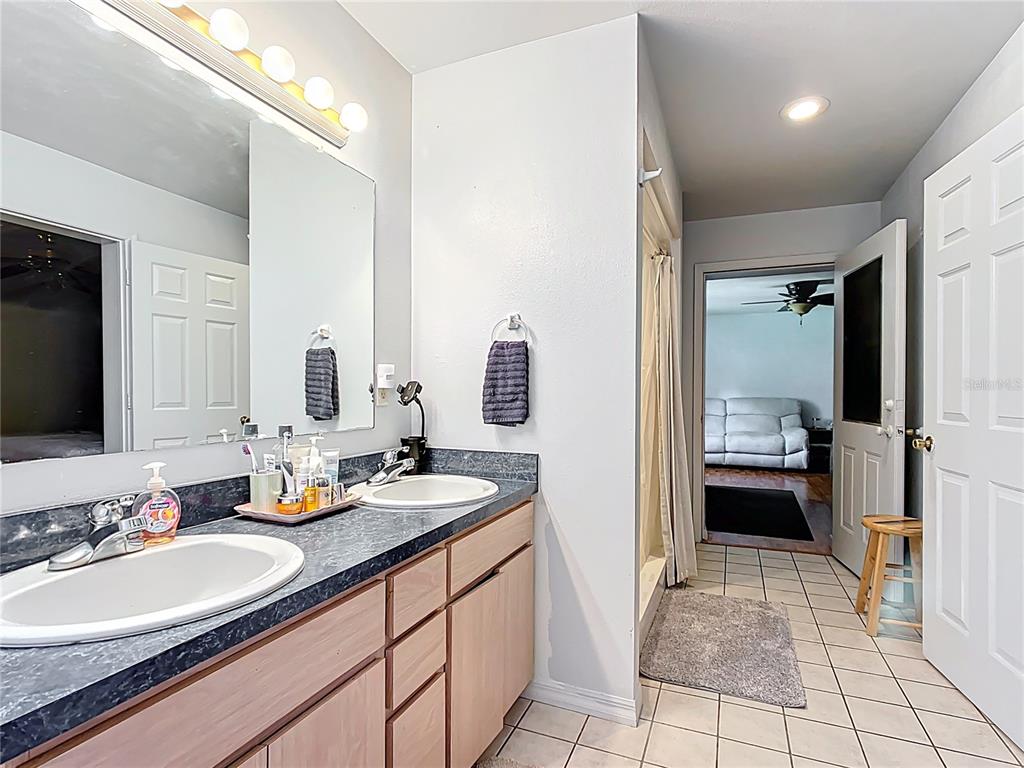 1405 East Clinton Street Bartow, FL 33830 - Photo 12 of 25 a en suite bathroom with a double vanity sink and a mirror