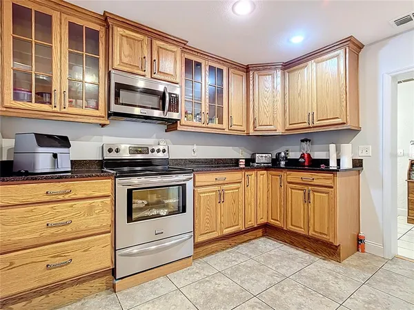 a kitchen with stainless steel appliances granite countertop a refrigerator and a sink